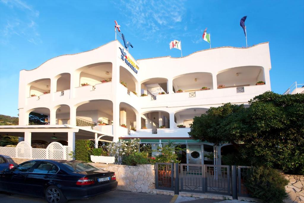 玛丽娜塞拉伊尔瓦赛罗酒店的前面有一辆汽车停放的白色建筑