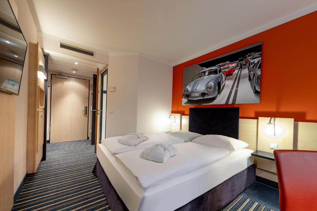 斯图加特斯特伽特城中心美居酒店的卧室配有一张床和一幅汽车照片