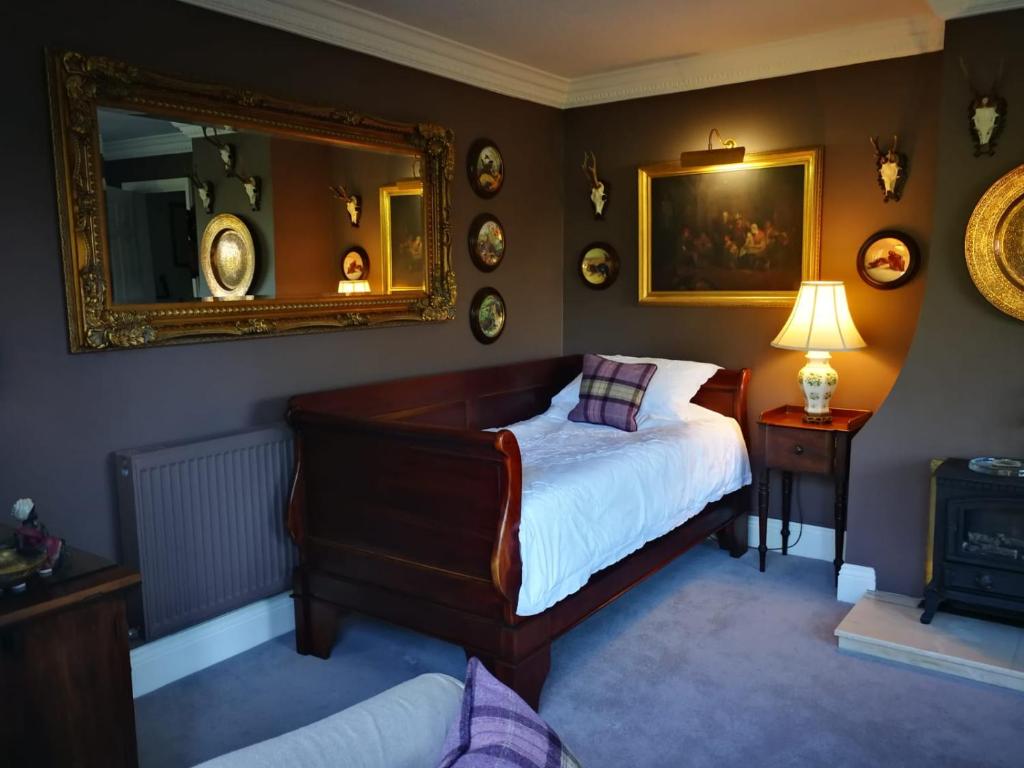 安德沃Staggs Cottage的一间卧室配有一张床和镜子