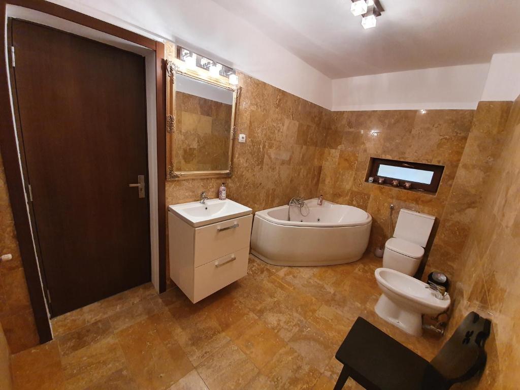 奥拉迪亚Vila De la Lugas的带浴缸、盥洗盆和卫生间的浴室