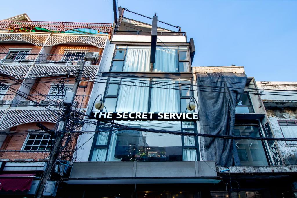 曼谷The Secret Service Bed & Breakfast的带有读阅特务的标志的建筑物