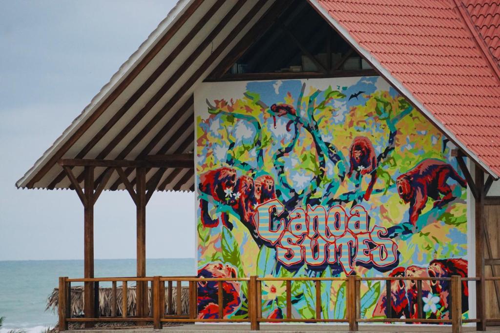 卡诺阿Canoa Suites的海滩旁一座建筑的一面壁画