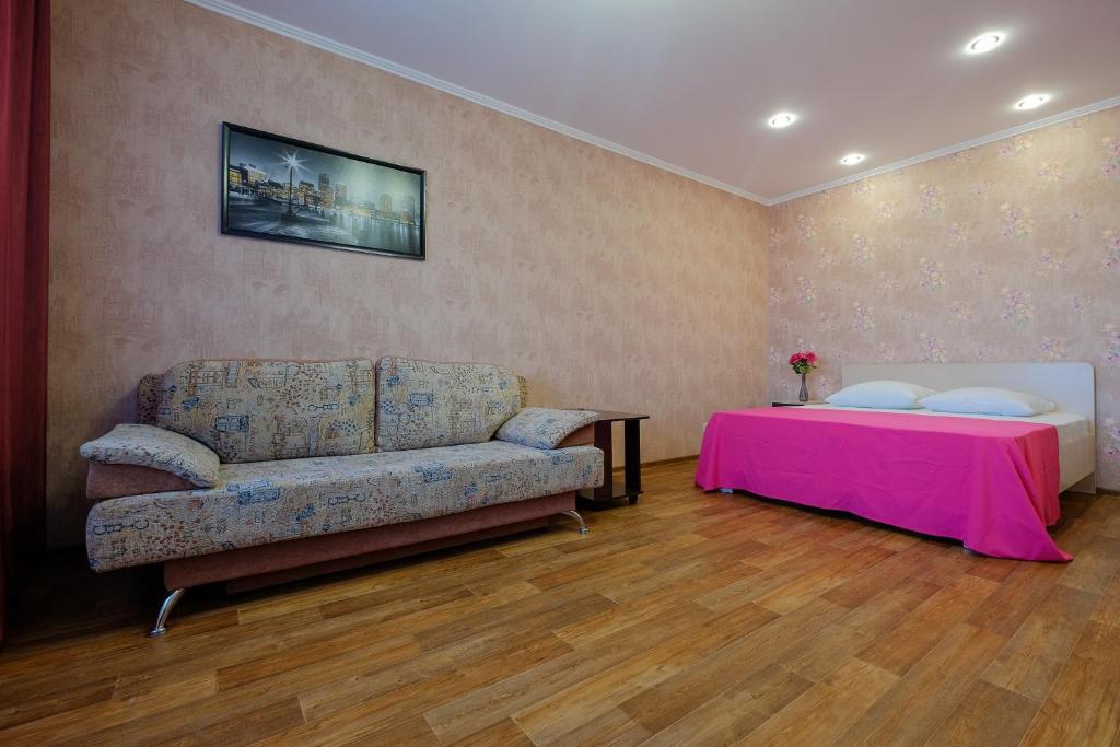 托木斯克ОК! Советская, 60 №1的客厅配有沙发和1张床