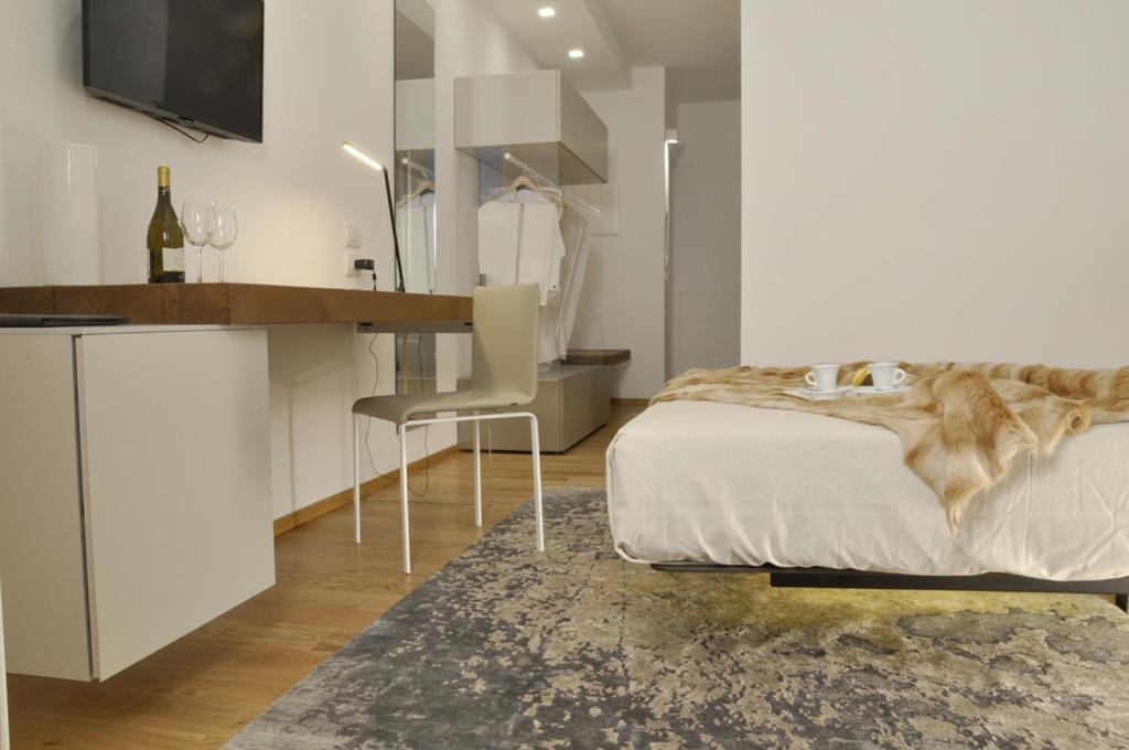 Belforte del ChientiChiaroscuro的一间卧室配有一张床、一张桌子和一张书桌