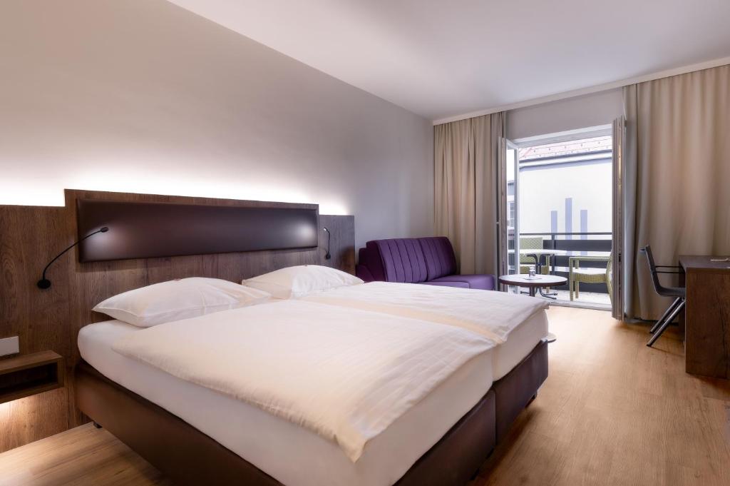 施托克劳 斯托克劳城市酒店的酒店客房设有一张大床和一个阳台。