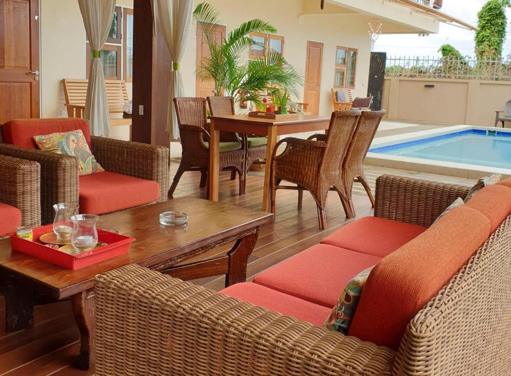 帕拉马里博Amalia Apartments的客厅配有桌椅和游泳池