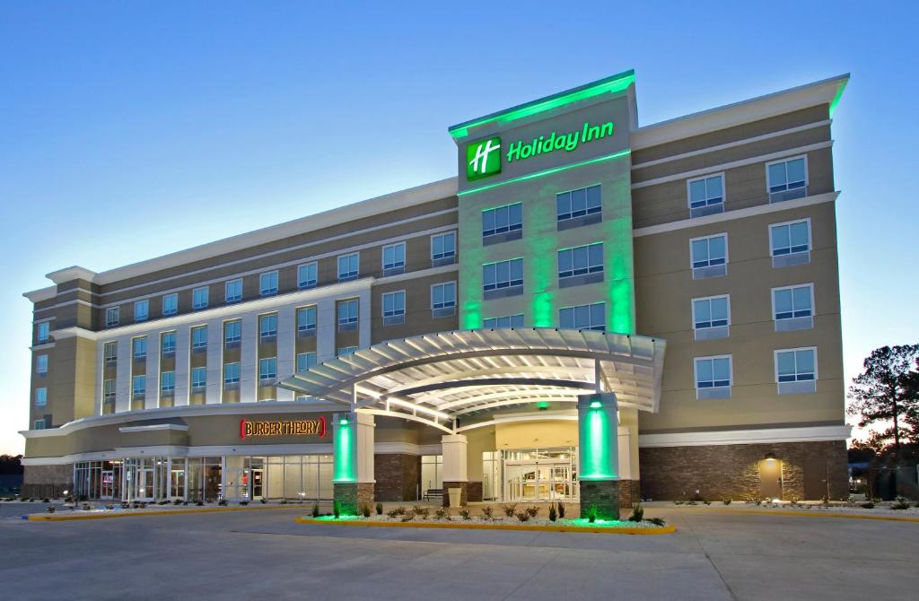 哈蒂斯堡Holiday Inn Hattiesburg - North, an IHG Hotel的一座酒店大楼,前面有标志