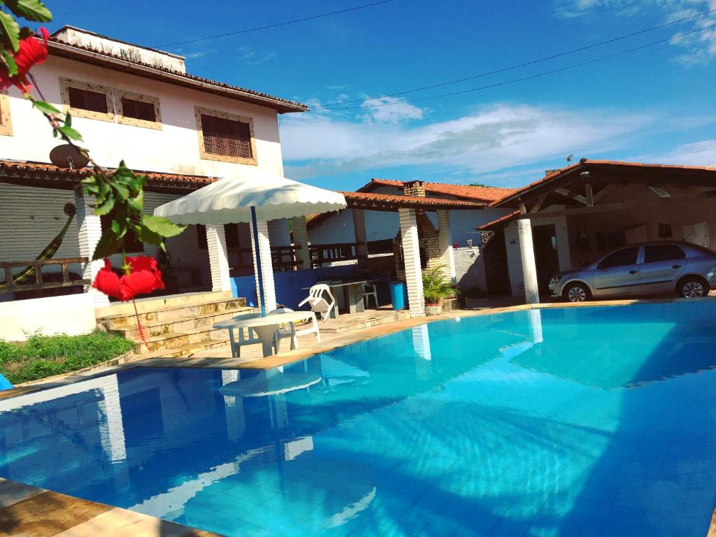 帕拉库鲁Beach House Paracuru B&B - cama e café的一座大蓝色游泳池,位于房子前