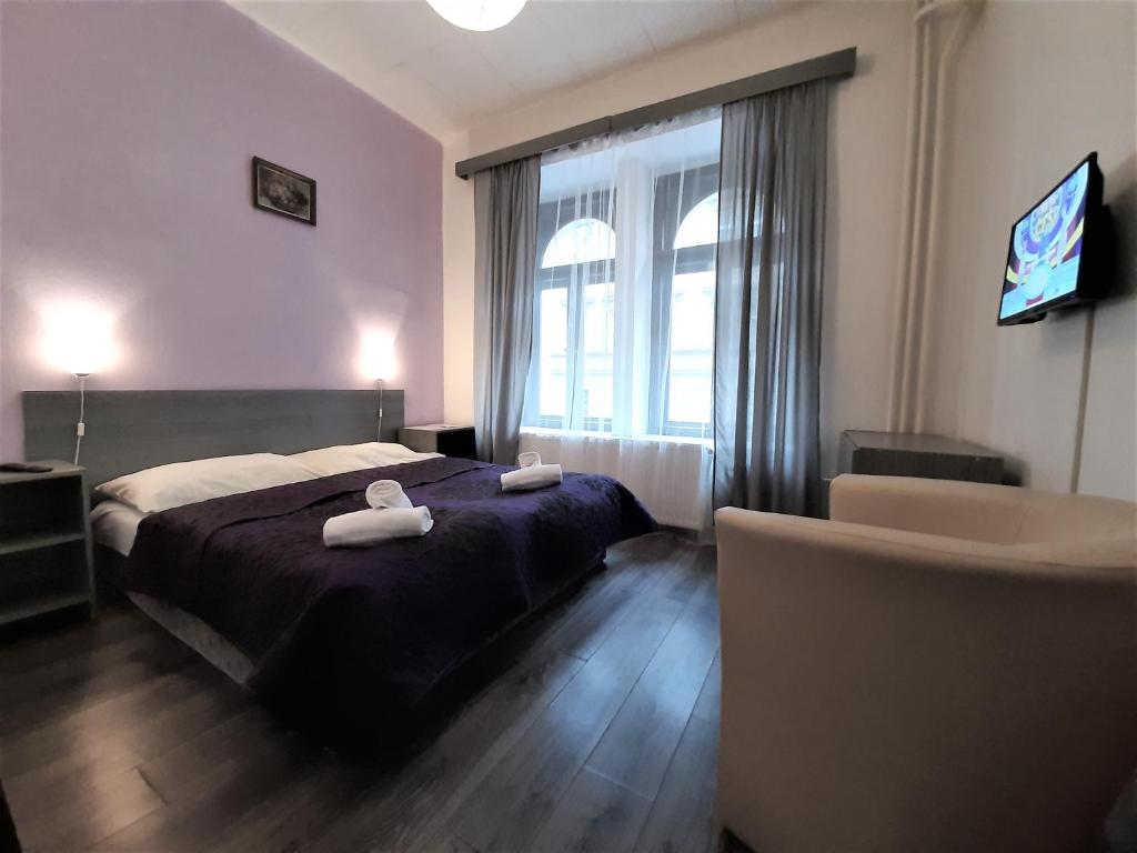 布拉格奥尔加酒店 的一间卧室配有一张床,上面有两条毛巾