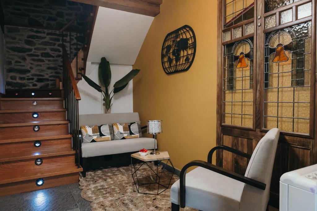 圣地亚哥－德孔波斯特拉PR纳斯圣胡安旅馆的带沙发和彩色玻璃窗的客厅