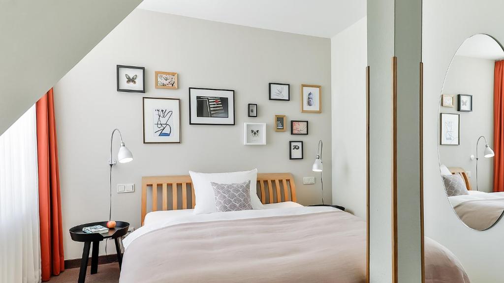 美因河畔法兰克福奥兰治别墅生态酒店的卧室配有两张床,墙上挂有图片