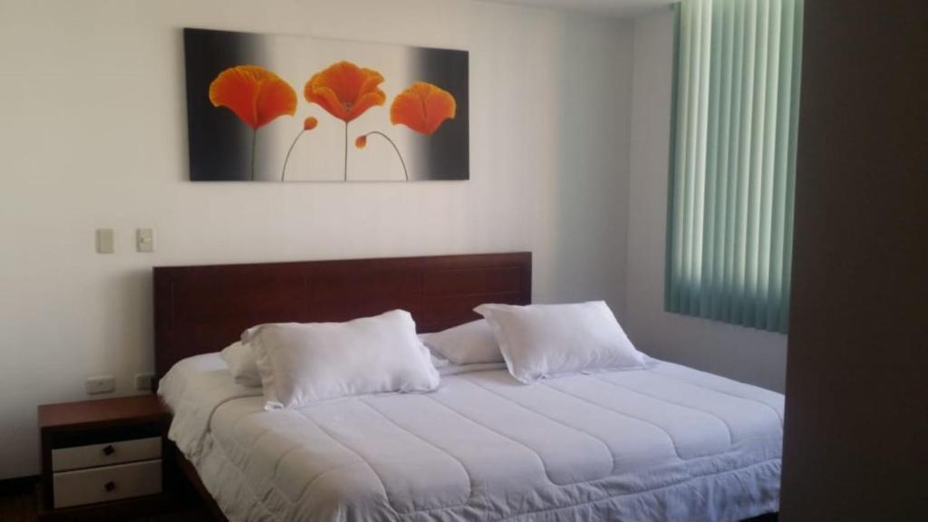 Misuitehotel La Carolina Quito客房内的一张或多张床位