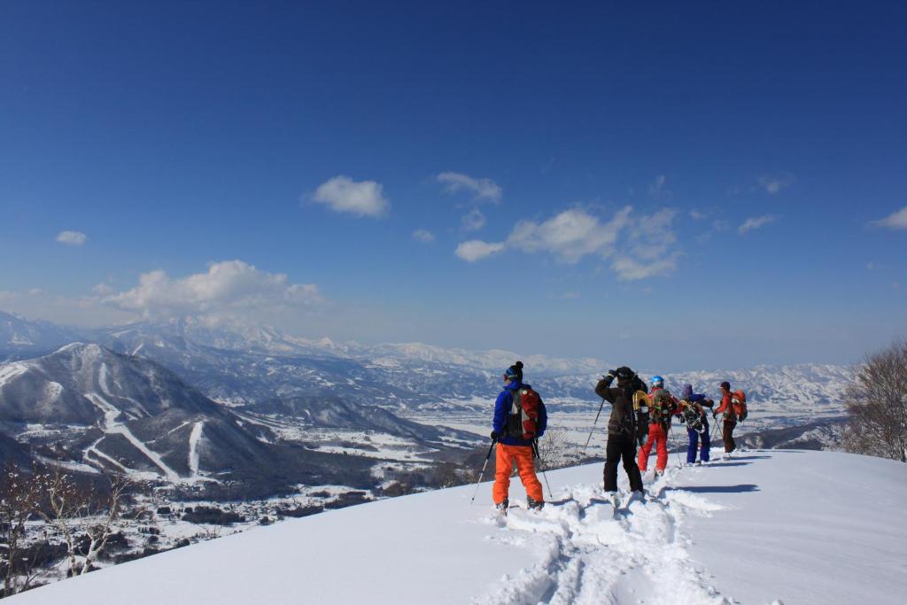 山之内町滋贺阿斯彭酒店的一群人站在雪覆盖的山顶上