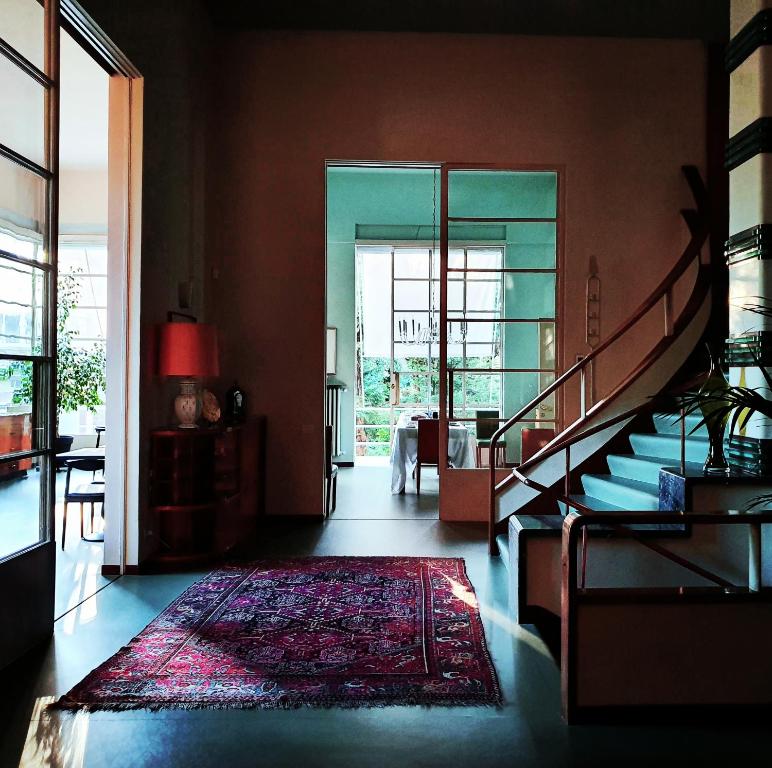 博洛尼亚Villa Gotti Charming Rooms的一间带楼梯和地毯的客厅