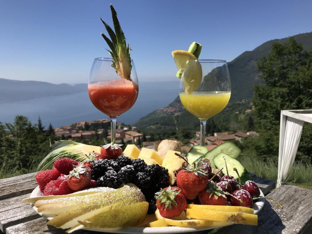 提尼亚类BnB Borgo le Vigne - La Vendemmia的桌上一盘水果和两杯酒杯