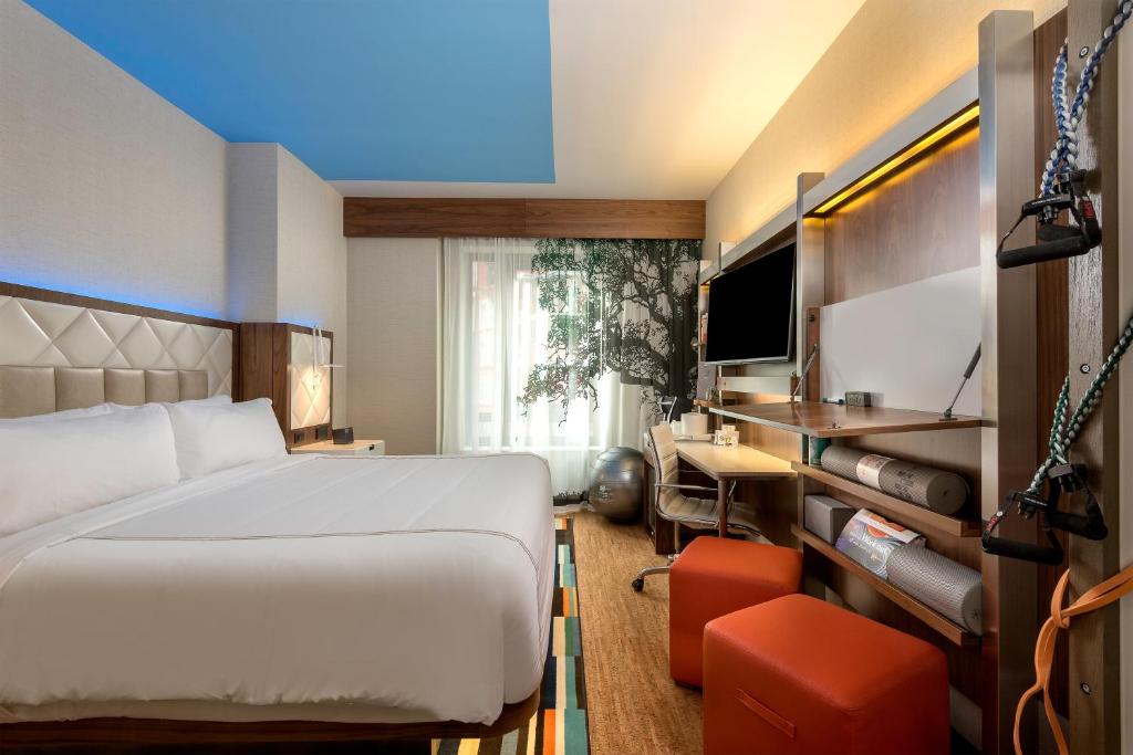 纽约EVEN Hotel New York - Midtown East, an IHG Hotel的一间卧室配有一张床、一张书桌和一台电视