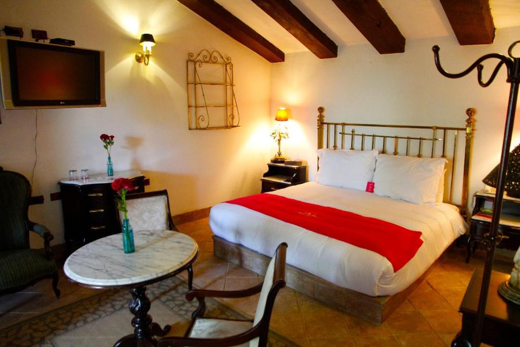 阿特利斯科Las Calandrias的一间卧室配有一张床、一张桌子和一台电视。