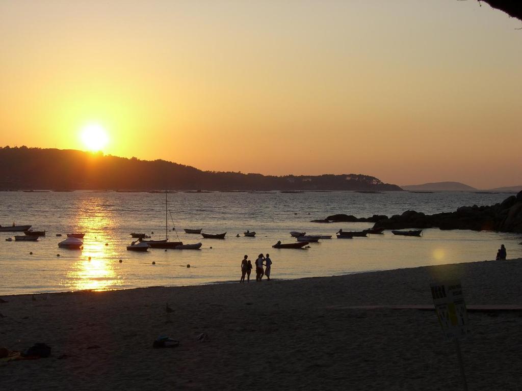 阿尔丹Faro de Aldan的一群人日落时在海滩上散步