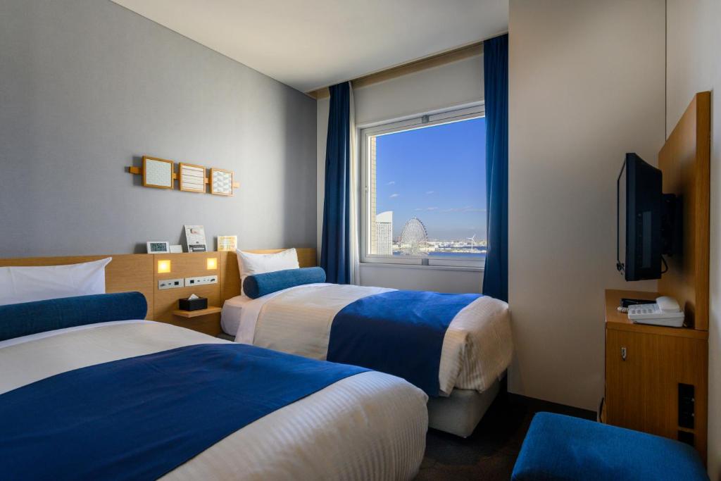 横滨横滨樱木町华盛顿酒店的酒店客房设有两张床和窗户。