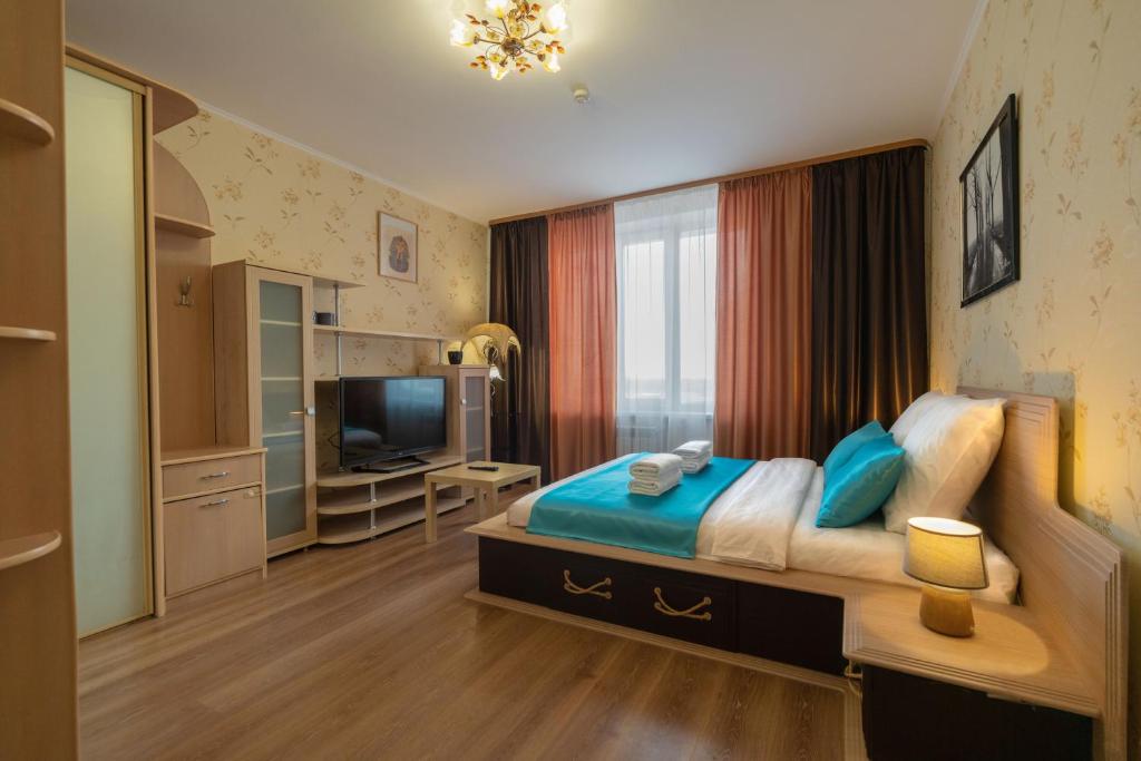 下瓦尔托夫斯克Five Stars Exquisite Taste的一间卧室配有一张大床和电视