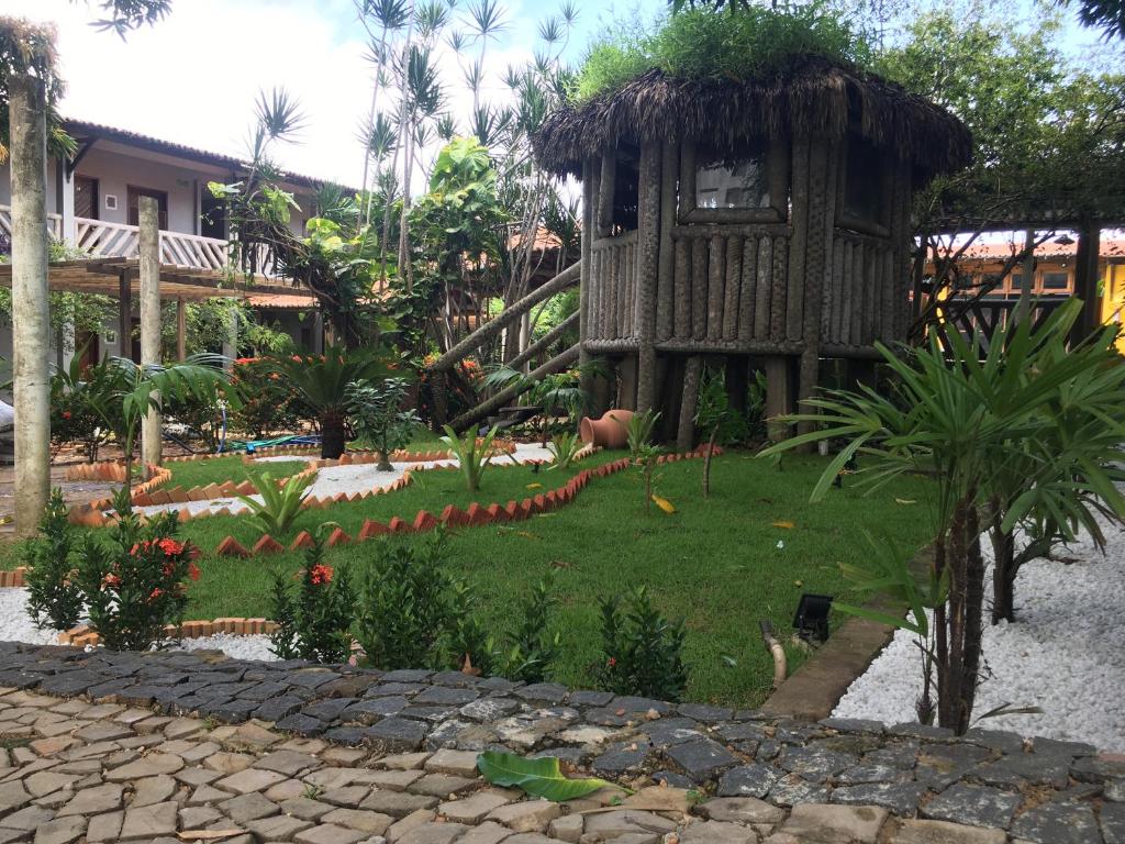 巴纳伊巴Hotel Pousada Dos Ventos的一座花园,位于一座带建筑物的度假村前