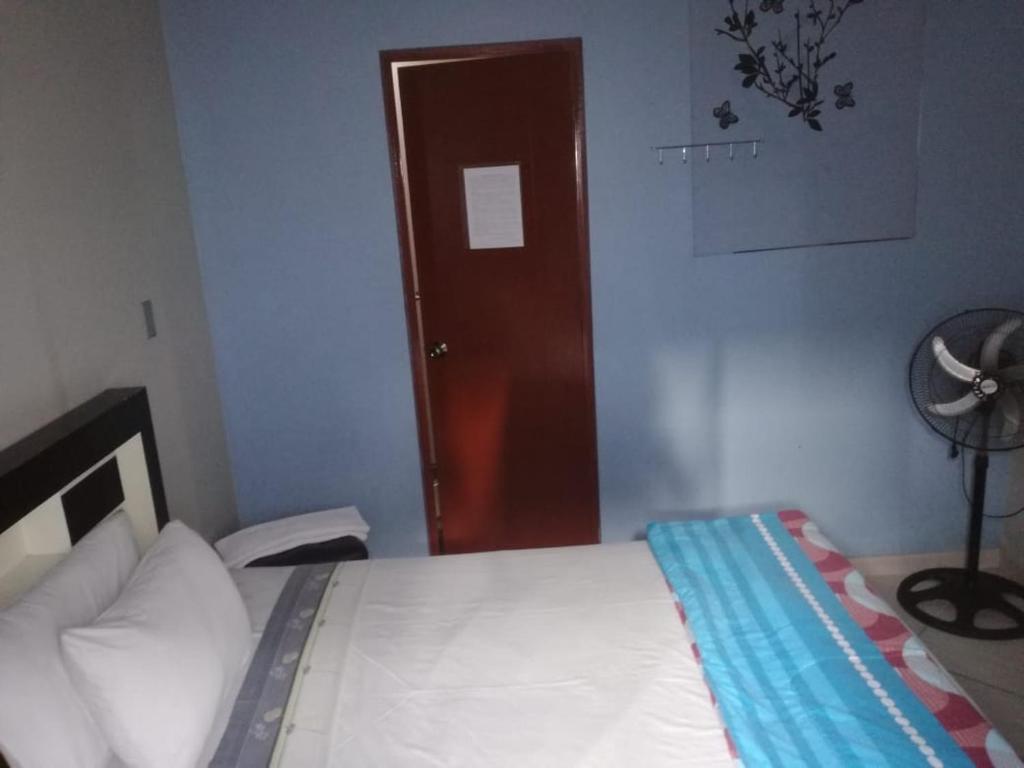 上钦查Bella Durmiente Hotel & Eventos的一间卧室设有一张床和一个棕色的门
