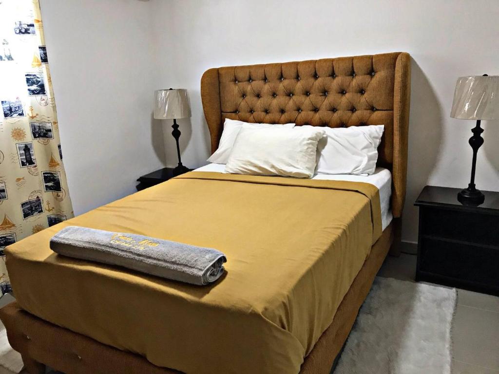 苏莎亚Charming 1b Apto Walk To The Beaches & Main Street的一间卧室配有一张带黄毯和两盏灯的床。