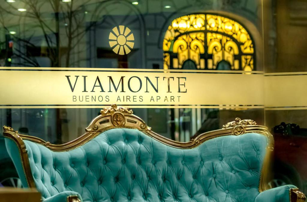 布宜诺斯艾利斯Up Viamonte Hotel的商店窗口的长凳,上面有读佛蒙特书的标志