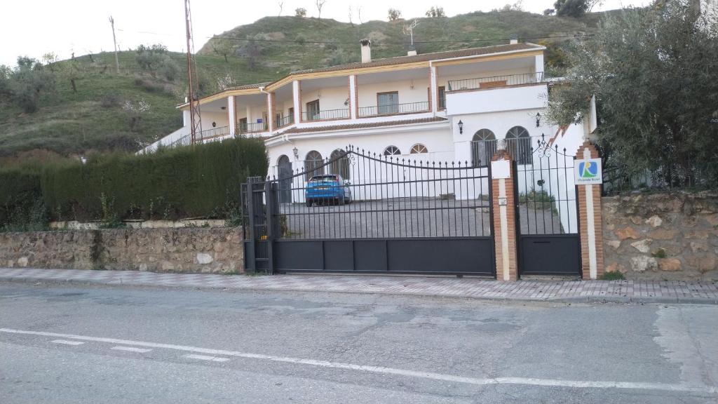 FrailesAlojamiento Árdales的一座带黑色门的大型白色房屋