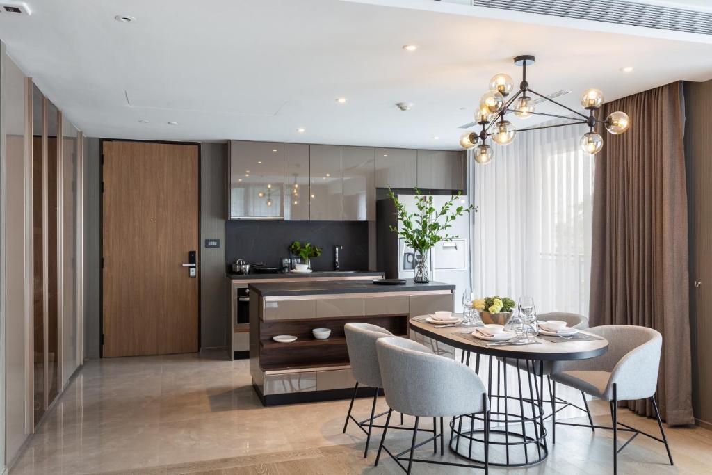 曼谷曼谷素坤逸莎玛 Luxe 服务式公寓的厨房以及带桌椅的用餐室。