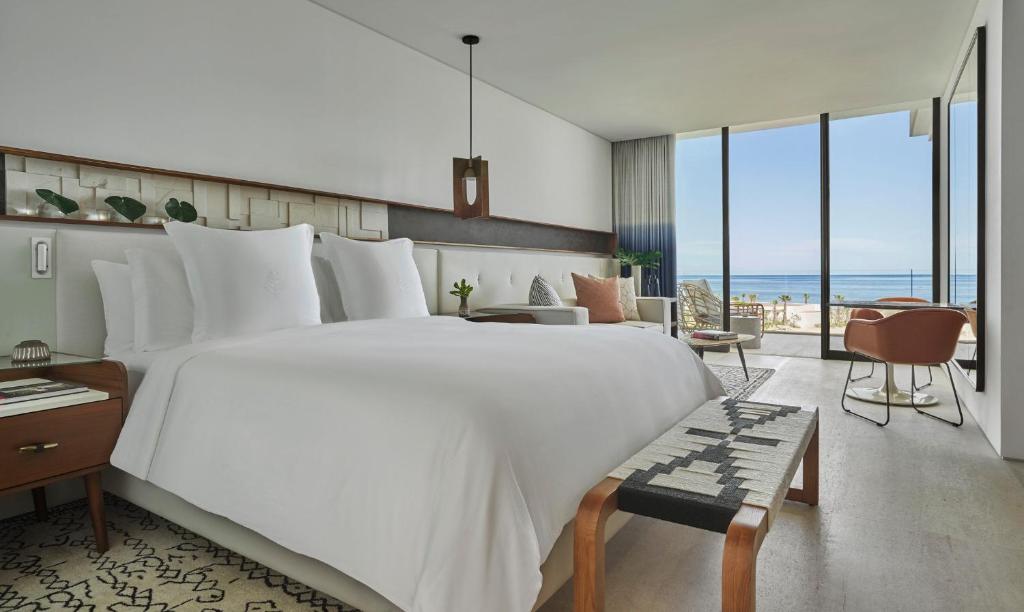 La RiberaFour Seasons Resort Los Cabos的卧室设有一张大白色床,享有海景
