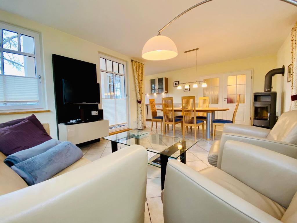 赛巴特班森Neue Villa Ernst - Ferienwohnung 4的客厅配有2张白色沙发和1张桌子