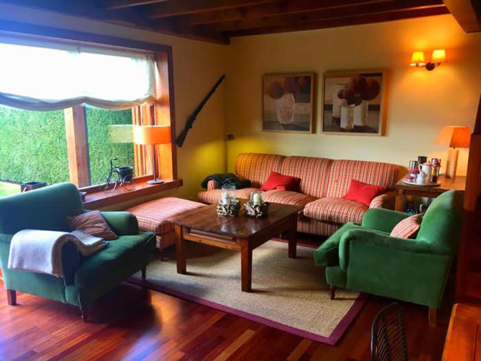 AngoustrineCasa adosada con piscina en Agoustrina的客厅配有沙发、椅子和桌子