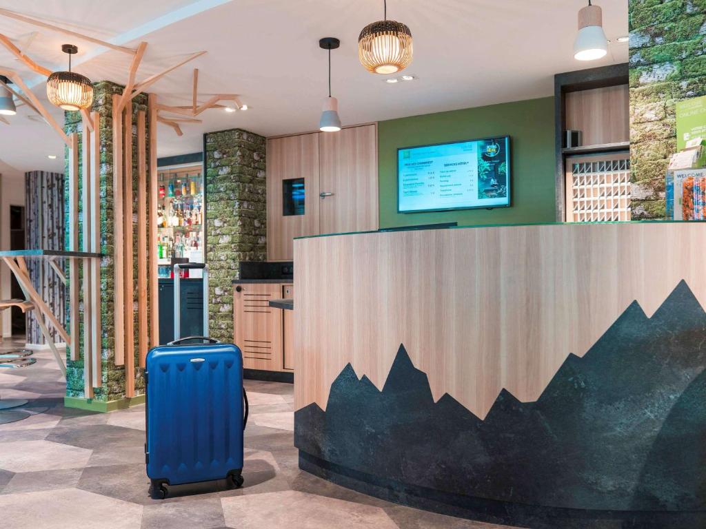安锡阿讷西中心火车站宜必思尚品酒店的放在商店大厅的蓝色手提箱