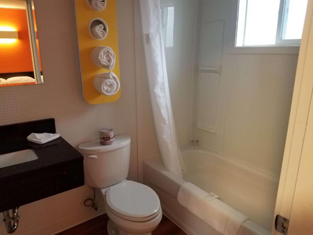 克兰布鲁克诺麦德汽车旅馆的浴室配有卫生间、淋浴和浴缸。