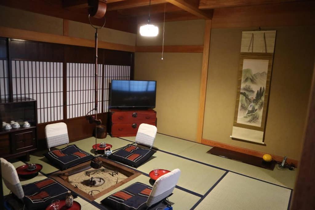 古川町Yoshiki Stay的客厅配有桌椅和电视。