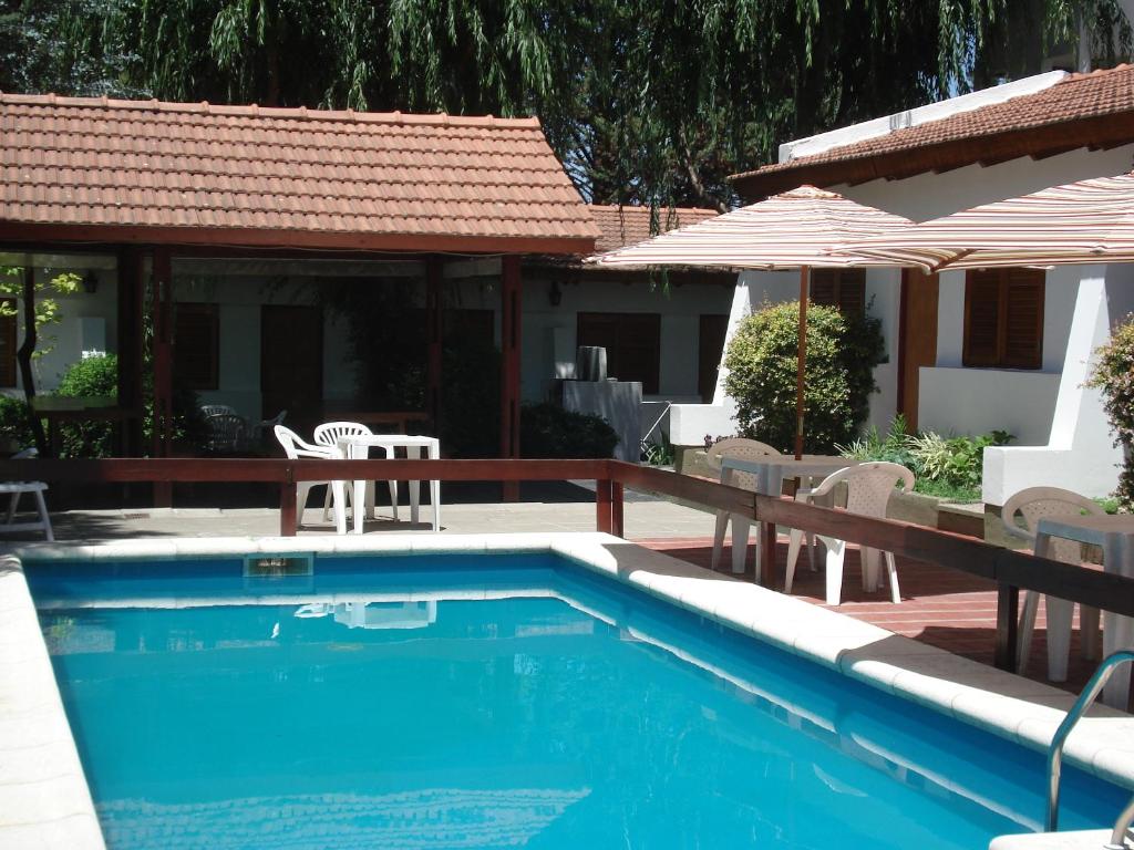 贝尔格拉诺将军镇El Agora的房屋旁的游泳池配有椅子和遮阳伞