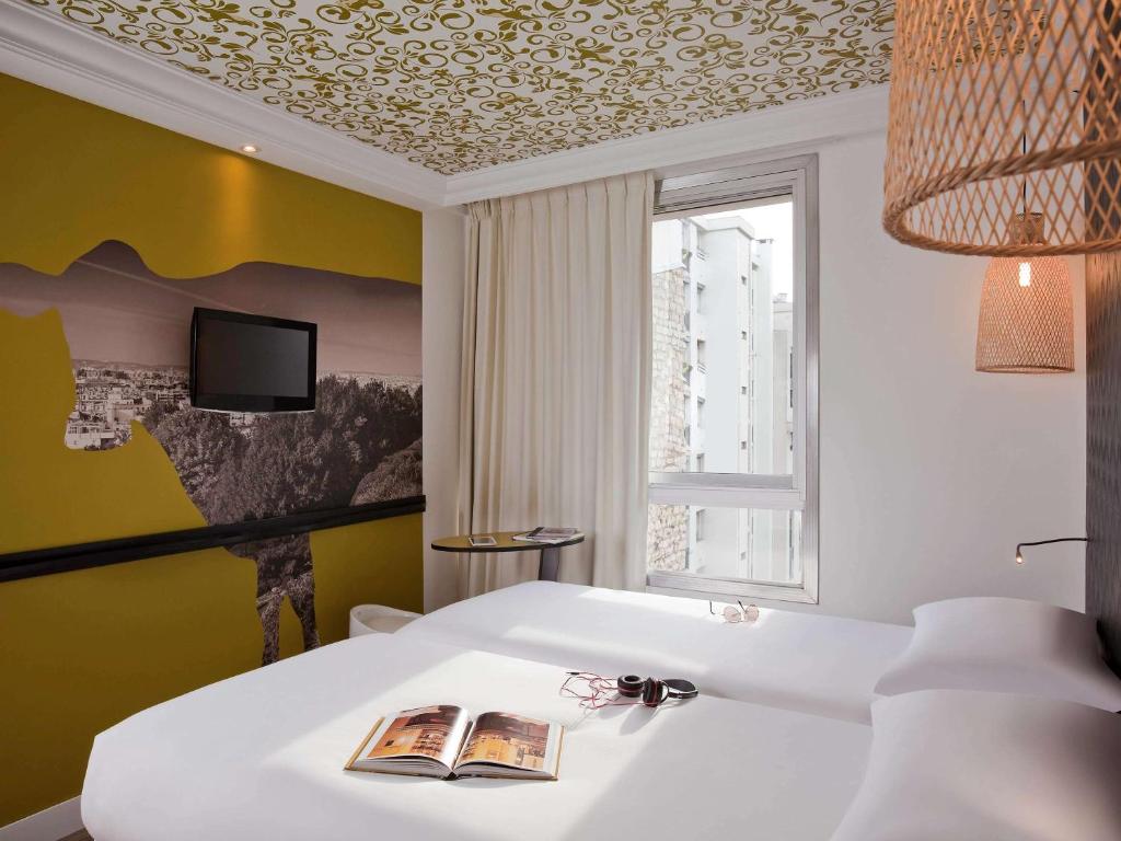巴黎巴黎巴茨肖蒙宜必思时尚酒店 的卧室配有白色的床和窗户。