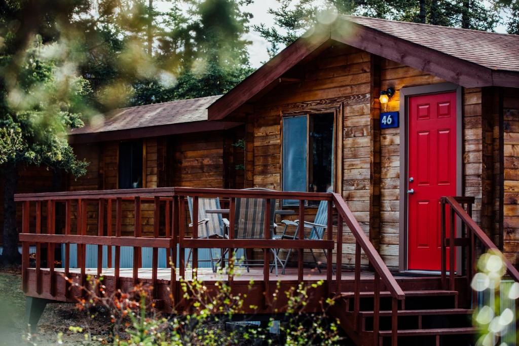 麦金利公园迪纳利小屋旅馆的小木屋设有红色的门和甲板