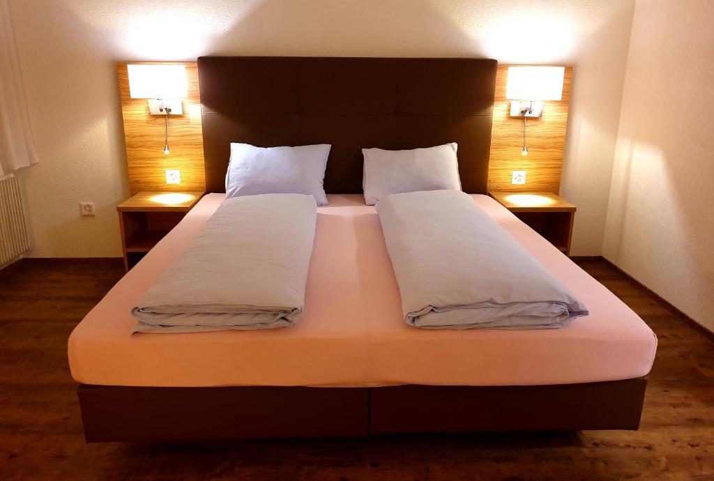 措芬根罗姆巴德酒店的一间卧室配有一张大床和两个枕头