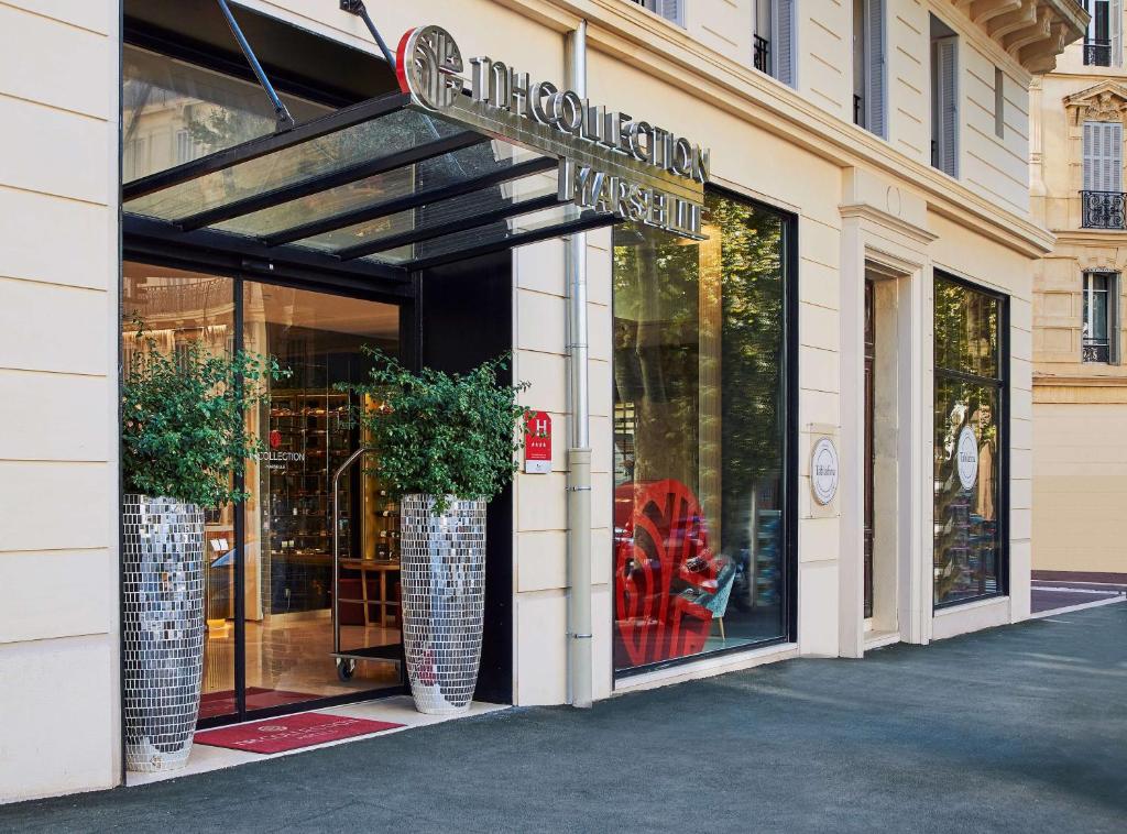 马赛马赛乔利酒店的前面有两只大花瓶的商店