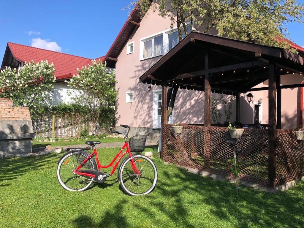 克里斯蒂安Holiday Home GC30的停在房子前面的草上的一个红色自行车