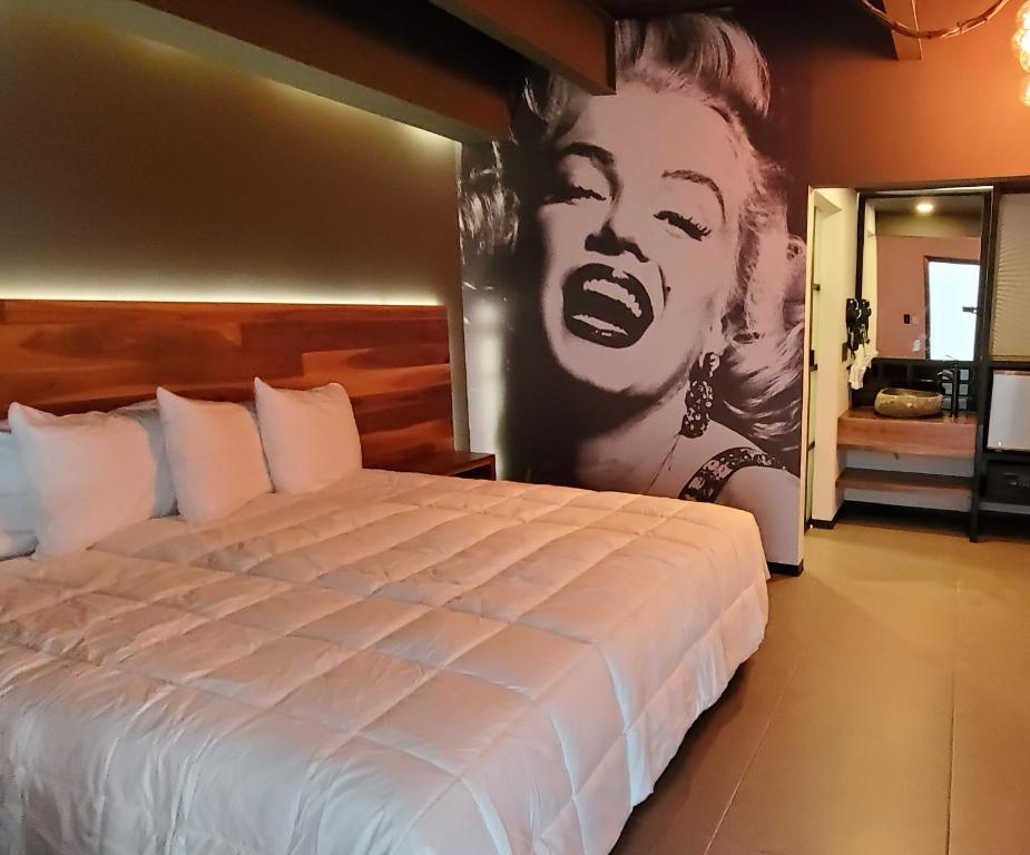 提华纳HOTEL RIO RITA的卧室配有一张带一张大女海报的床