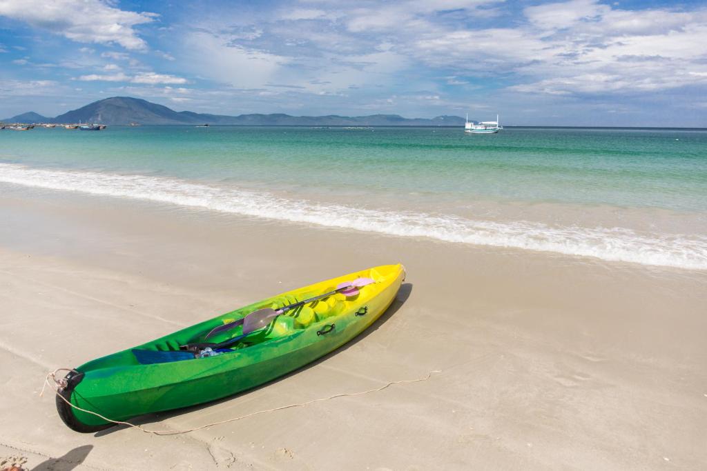 雷特Paradise Resort Doc Let的海滩上一艘绿色和黄色的皮艇
