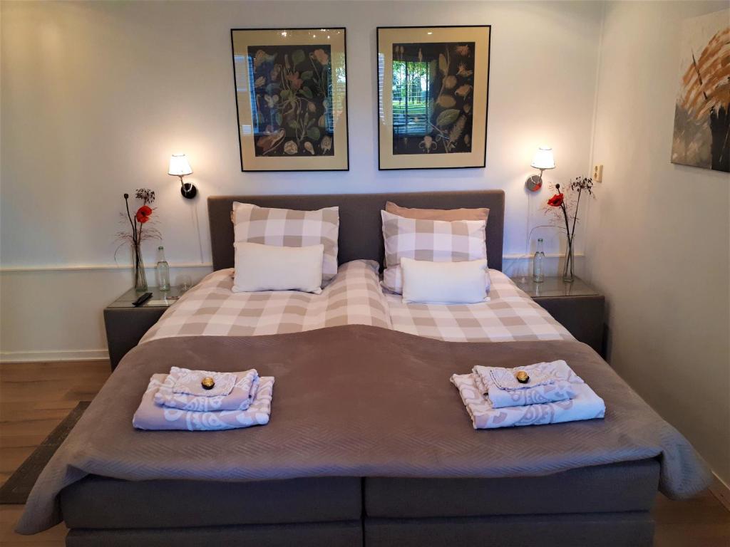 HooghalenB&B de Panheide的一间卧室配有一张大床和毛巾