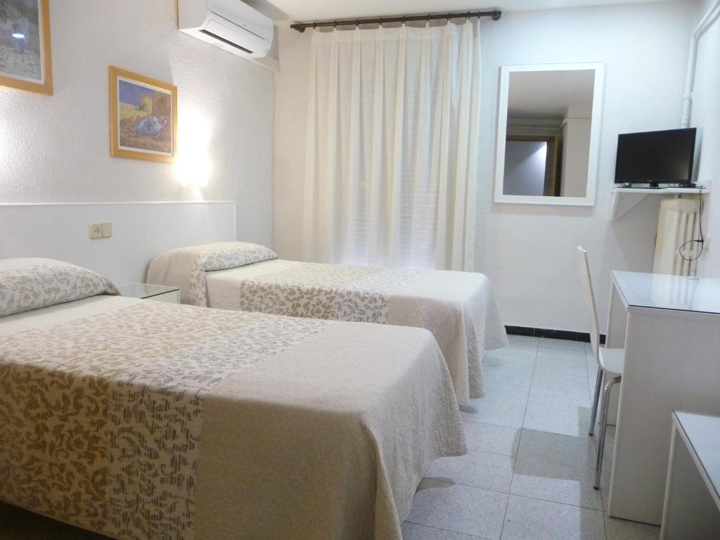 莱里达戈雅酒店的酒店客房设有三张床和电视。