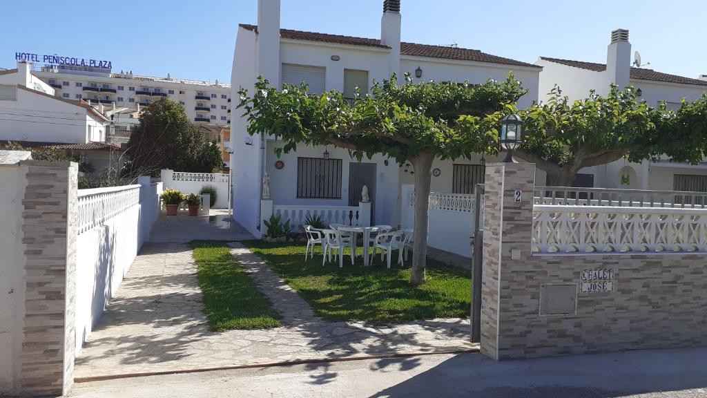 佩尼斯科拉Chalet Jose的白色的房子,配有桌子和围栏