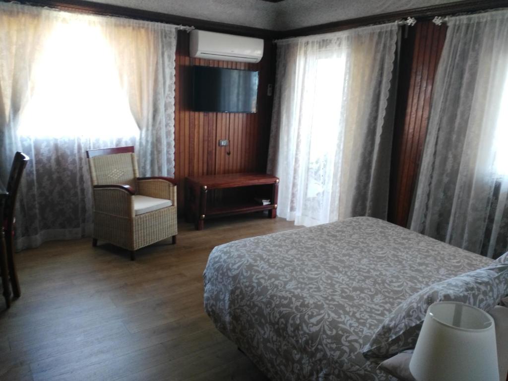 La EsperanzaHOSPEDAJE TU SITIO的一间卧室配有一张床、一把椅子和窗户。