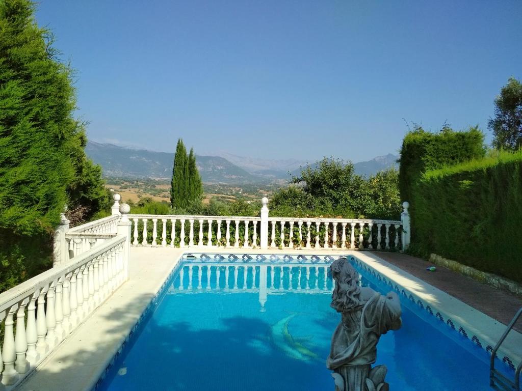 普拉多德尔雷4 bedrooms villa with private pool enclosed garden and wifi at Prado del Rey的一个带白色围栏和雕像的游泳池
