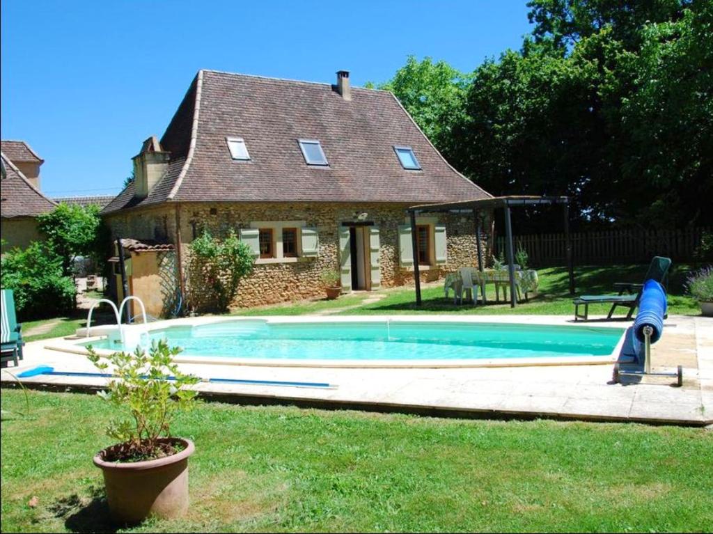 Saint-AlvèreMaison d'une chambre avec piscine privee jardin amenage et wifi a Sainte Alvere的房屋前有游泳池的房子